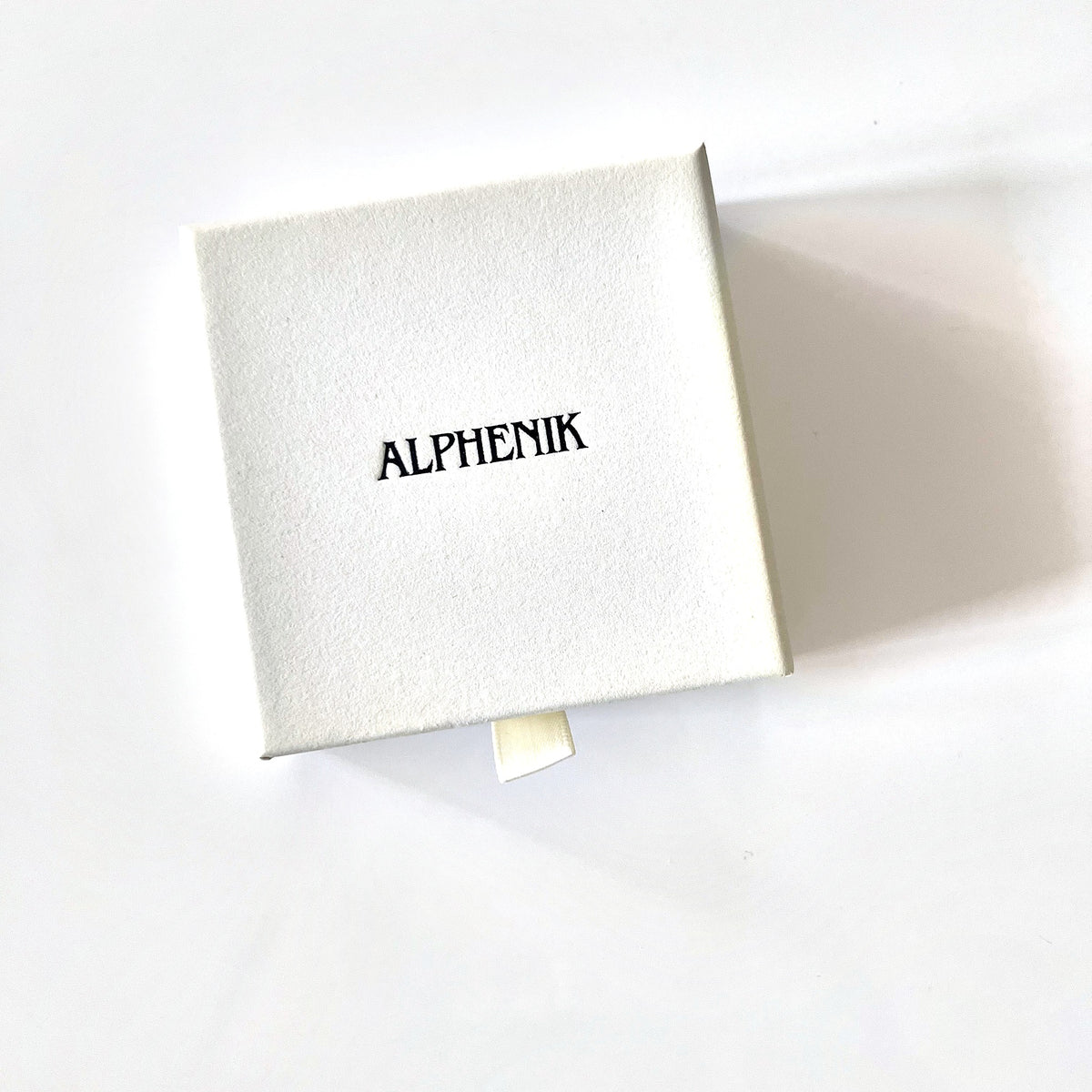 Alphenik gift box, closed — cream drawer box with embossed logo