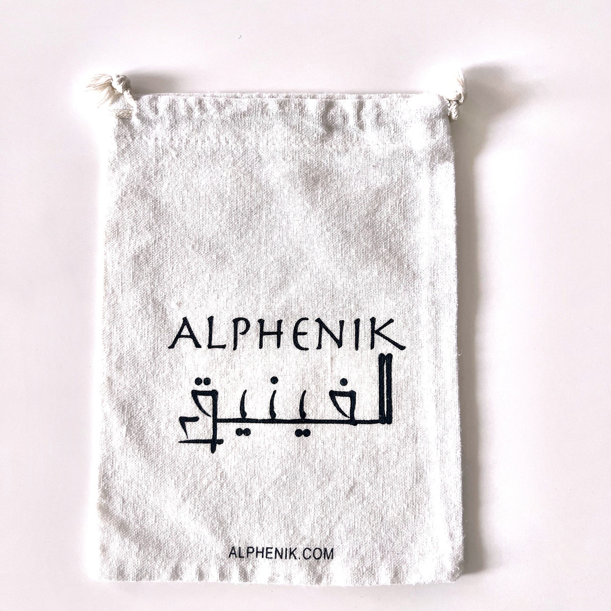 Alphenik signature cotton pouch — included free with every order